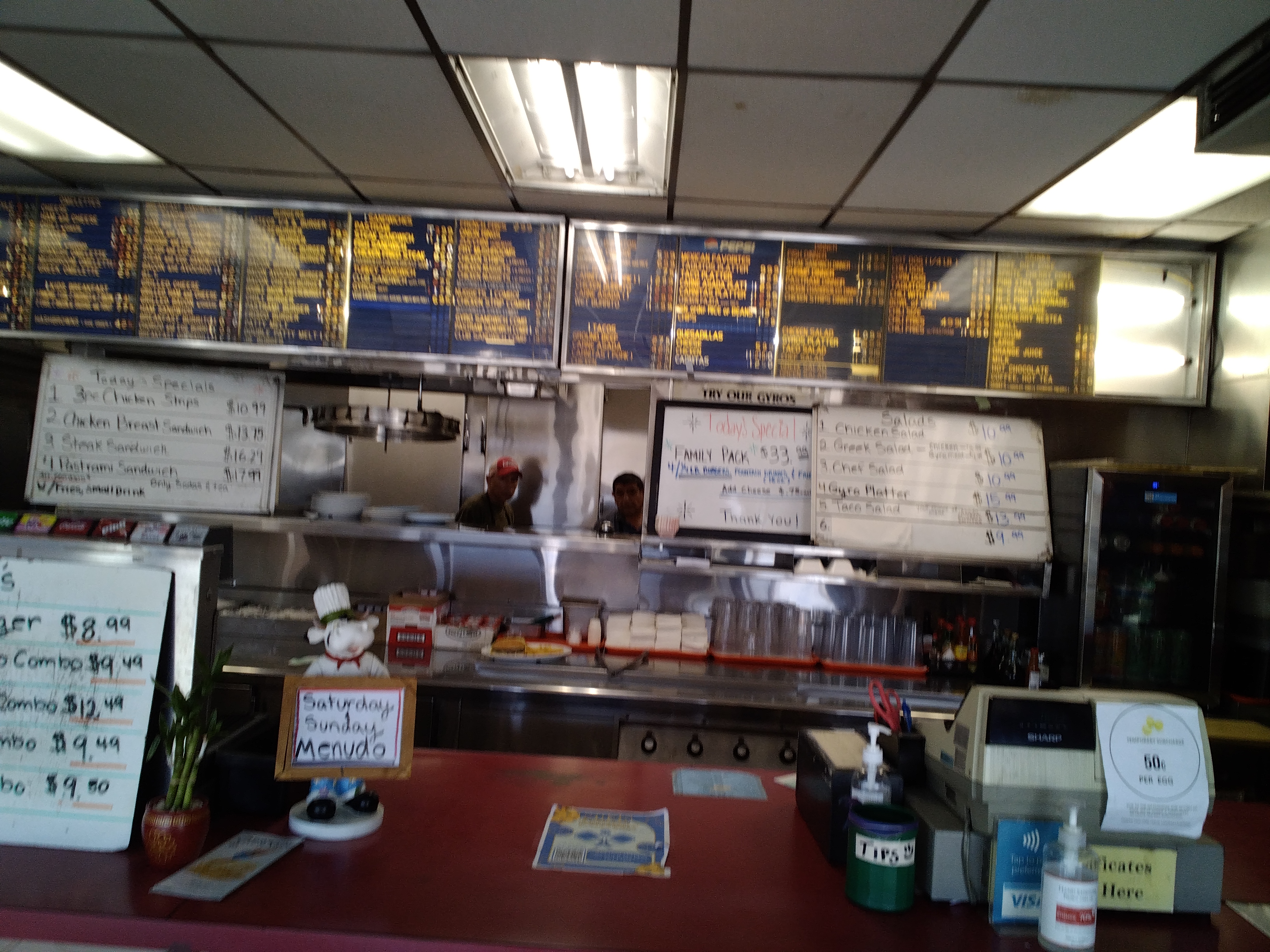 Behind the counter — grill line and menu boards