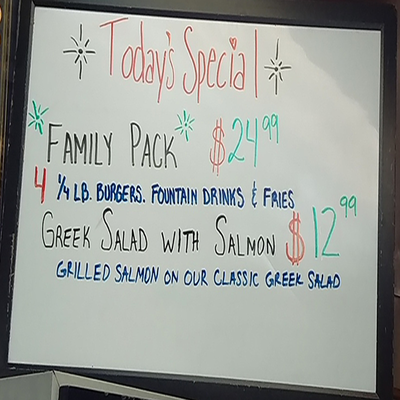 Today's Special whiteboard — Family Pack $24.99 with 4 quarter-pound burgers, fountain drinks and fries